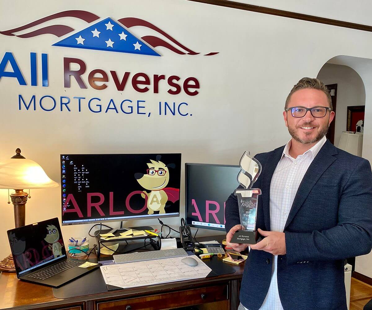 Cliff Auerswald holding BBB torch ethics award